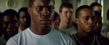 Movie still from “Remember the Titans” (2000), directed by Boaz Yakin – A group of men standing next to each other in a room; Close Up shot, Low angle