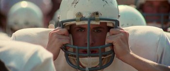 Movie still from “Remember the Titans” (2000), directed by Boaz Yakin – A person wearing a football helmet; Close Up shot, Low angle