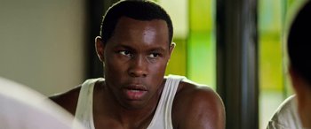 Movie still from “Remember the Titans” (2000), directed by Boaz Yakin – A person wearing a white shirt; Close Up shot, Low angle