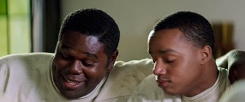 Movie still from “Remember the Titans” (2000), directed by Boaz Yakin – A couple of men sitting next to each other; Close Up shot, High angle