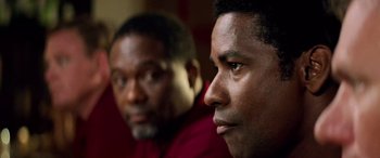 Movie still from “Remember the Titans” (2000), directed by Boaz Yakin – Two men sitting next to each other in front of a window; Close Up shot, Over the shoulder angle