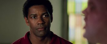 Movie still from “Remember the Titans” (2000), directed by Boaz Yakin – A person wearing a red shirt; Close Up shot, Over the shoulder angle