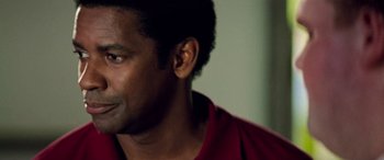 Movie still from “Remember the Titans” (2000), directed by Boaz Yakin – A person wearing a red shirt; Close Up shot, Over the shoulder angle