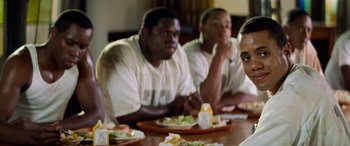 Movie still from “Remember the Titans” (2000), directed by Boaz Yakin – A group of people sitting at a table with food; Close Up shot, Over the shoulder angle