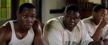 Movie still from “Remember the Titans” (2000), directed by Boaz Yakin – Two men sitting next to each other in front of a wall; Close Up shot, Over the shoulder angle