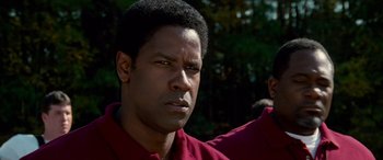 Movie still from “Remember the Titans” (2000), directed by Boaz Yakin – A person wearing a red shirt; Close Up shot, Low angle