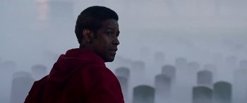 Movie still from “Remember the Titans” (2000), directed by Boaz Yakin – A man standing in front of a row of tombstones; Close Up shot, Low angle