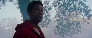 Movie still from “Remember the Titans” (2000), directed by Boaz Yakin – A man standing in front of a tree looking off into the distance; Close Up shot, Low angle
