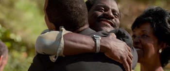 Movie still from “Remember the Titans” (2000), directed by Boaz Yakin – A man hugging another man with his arm around another man; Close Up shot, Low angle