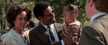 Movie still from “Remember the Titans” (2000), directed by Boaz Yakin – A man holding a little girl in his arms; Close Up shot, Over the shoulder angle