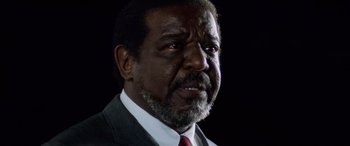 Movie still from “Remember the Titans” (2000), directed by Boaz Yakin – An older man with a beard and a red neck tie; Close Up shot, Low angle