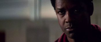 Movie still from “Remember the Titans” (2000), directed by Boaz Yakin – A man's face in a dark room; Close Up shot, Low angle