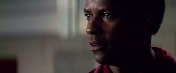 Movie still from “Remember the Titans” (2000), directed by Boaz Yakin – A man's face in a red shirt; Close Up shot, Over the shoulder angle