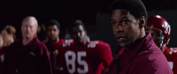 Movie still from “Remember the Titans” (2000), directed by Boaz Yakin – A group of football players standing next to each other; Close Up shot, Over the shoulder angle