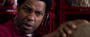 Movie still from “Remember the Titans” (2000), directed by Boaz Yakin – A person with a red shirt; Close Up shot, Low angle