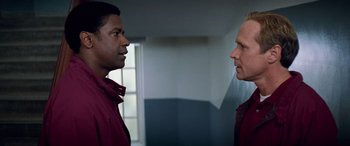 Movie still from “Remember the Titans” (2000), directed by Boaz Yakin – Two men are facing each other in a room; Close Up shot, Over the shoulder angle
