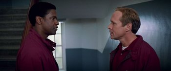 Movie still from “Remember the Titans” (2000), directed by Boaz Yakin – Two men are facing each other in a room; Close Up shot, Over the shoulder angle