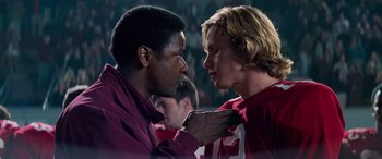 Movie still from “Remember the Titans” (2000), directed by Boaz Yakin – Two young men are touching each other's faces; Close Up shot, Over the shoulder angle