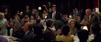 Movie still from “Remember the Titans” (2000), directed by Boaz Yakin – A group of people sitting at a table with candles; Wide shot, High angle