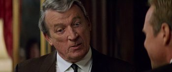 Movie still from “Remember the Titans” (2000), directed by Boaz Yakin – An older man wearing a suit and tie; Close Up shot, Over the shoulder angle