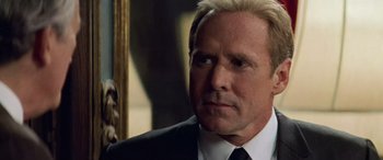 Movie still from “Remember the Titans” (2000), directed by Boaz Yakin – A man in a suit and tie looking to his left; Close Up shot, Over the shoulder angle