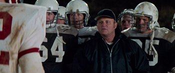 Movie still from “Remember the Titans” (2000), directed by Boaz Yakin – A group of football players standing next to each other; Medium shot, Over the shoulder angle