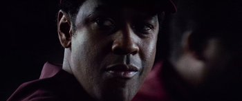 Movie still from “Remember the Titans” (2000), directed by Boaz Yakin – A man's face in the dark; Close Up shot, Over the shoulder angle