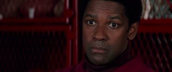 Movie still from “Remember the Titans” (2000), directed by Boaz Yakin – Denzel washington's face in front of a red background; Close Up shot, Low angle