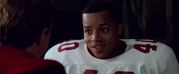 Movie still from “Remember the Titans” (2000), directed by Boaz Yakin – A football player smiling for the camera; Close Up shot, Over the shoulder angle