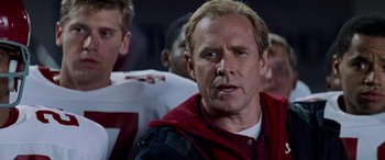 Movie still from “Remember the Titans” (2000), directed by Boaz Yakin – A football player wearing a red and white uniform; Close Up shot, Low angle