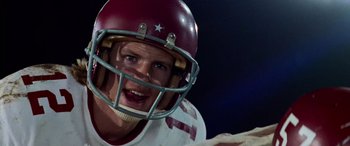 Movie still from “Remember the Titans” (2000), directed by Boaz Yakin – A man in a football uniform with a helmet on; Close Up shot, Low angle