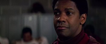 Movie still from “Remember the Titans” (2000), directed by Boaz Yakin – A man's face in a dark room; Close Up shot, Low angle