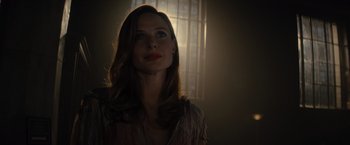 Movie still from “Reminiscence” (2021), directed by Lisa Joy – A beautiful woman with long brown hair looking up at the sky; Close Up shot, Low angle