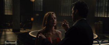 Movie still from “Reminiscence” (2021), directed by Lisa Joy – A man smoking a cigarette next to a beautiful woman; Medium shot, Over the shoulder angle