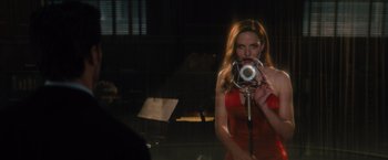Movie still from “Reminiscence” (2021), directed by Lisa Joy – A woman taking a picture of herself with a camera; Medium shot, Over the shoulder angle
