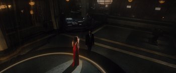 Movie still from “Reminiscence” (2021), directed by Lisa Joy – A woman in a red dress and a man in a black suit; Extreme Wide shot, High angle