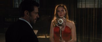 Movie still from “Reminiscence” (2021), directed by Lisa Joy – A man and a woman are looking at each other in a dark room; Medium shot, Over the shoulder angle