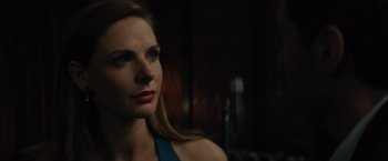 Movie still from “Reminiscence” (2021), directed by Lisa Joy – A beautiful woman with long blonde hair and blue eyes looking at the camera; Close Up shot, Over the shoulder angle
