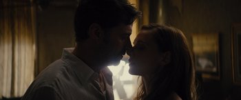 Movie still from “Reminiscence” (2021), directed by Lisa Joy – A man and a woman kissing in the dark; Close Up shot, Low angle