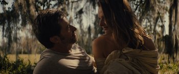 Movie still from “Reminiscence” (2021), directed by Lisa Joy – A man and a woman sitting next to each other; Close Up shot, Over the shoulder angle