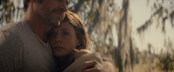 Movie still from “Reminiscence” (2021), directed by Lisa Joy – A man and a woman embracing each other in a wooded area; Close Up shot, Low angle