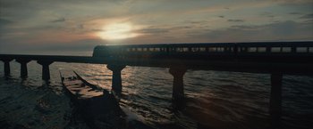 Movie still from “Reminiscence” (2021), directed by Lisa Joy – A train traveling over a body of water; Extreme Wide shot, Low angle