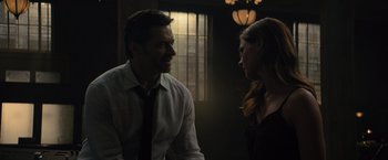 Movie still from “Reminiscence” (2021), directed by Lisa Joy – A man and a woman talking in a dark room; Close Up shot, Over the shoulder angle