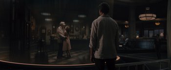 Movie still from “Reminiscence” (2021), directed by Lisa Joy – A man and a woman dancing in front of another man; Wide shot, Over the shoulder angle