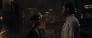 Movie still from “Reminiscence” (2021), directed by Lisa Joy – A woman and a man are standing in a dark room; Medium shot, Over the shoulder angle