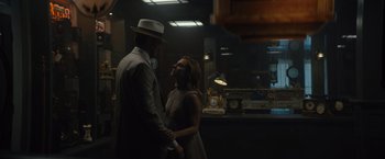 Movie still from “Reminiscence” (2021), directed by Lisa Joy – A man and a woman standing next to each other in a room; Medium shot, Over the shoulder angle