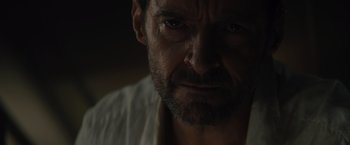 Movie still from “Reminiscence” (2021), directed by Lisa Joy – A man's face in the dark; Close Up shot, Over the shoulder angle