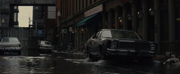 Movie still from “Reminiscence” (2021), directed by Lisa Joy – A car is parked on the side of the street; Extreme Wide shot, High angle