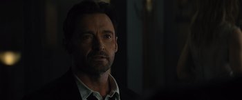 Movie still from “Reminiscence” (2021), directed by Lisa Joy – A person wearing a suit and tie; Close Up shot, Over the shoulder angle