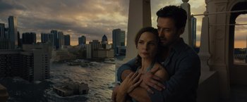Movie still from “Reminiscence” (2021), directed by Lisa Joy – A man and a woman hugging near a body of water; Close Up shot, Low angle